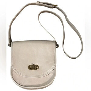 Lauren Merkin Stevie saddlebag style handbag, beige in color.